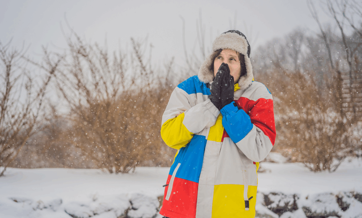 A person experiencing teeth sensitivity during one of Detroit's winters