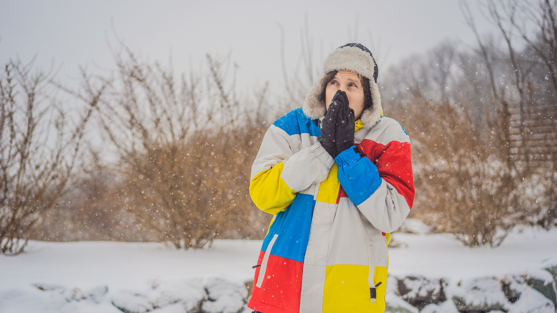 A person experiencing teeth sensitivity during one of Detroit's winters