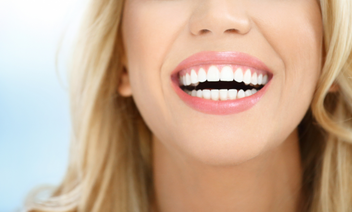 A photo of someone smiling in the Spring after their dental checkup with crestwood dental on the lake